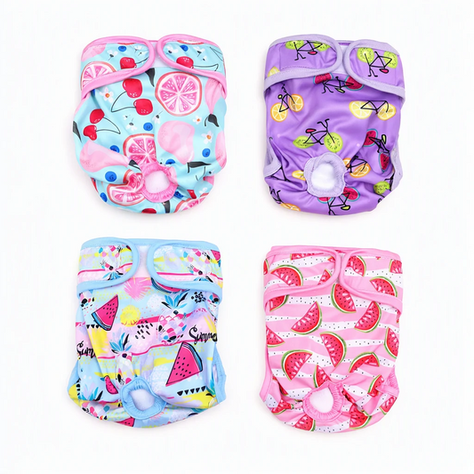 Four reusable washable female dog diapers in Cherry Lemon, Fruit & Bikes, Tropical Pineapple and Sweet Watermelon prints on a white background